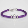 Pulsera en cordón de cabo morado con cierre mosquetón. Con Charm de Virgencita de Covadonga en plata de ley. Muestra principal.